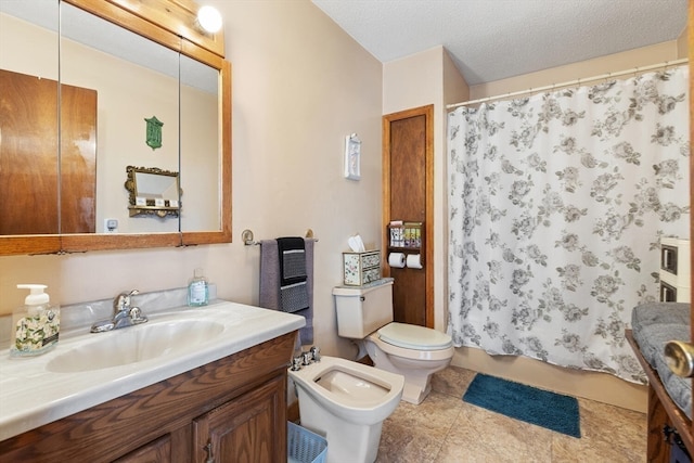 bathroom with vanity, a bidet, a shower with shower curtain, toilet, and a textured ceiling