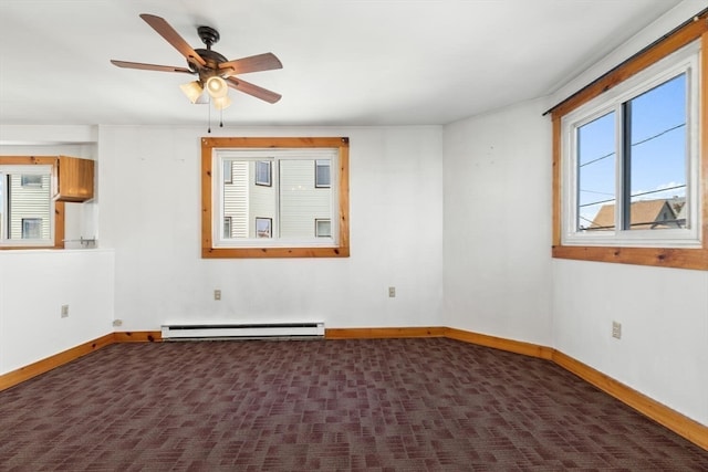 empty room featuring baseboard heating, ceiling fan, and dark carpet