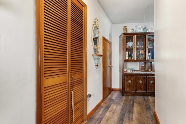 corridor with dark hardwood / wood-style floors