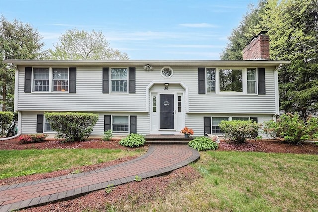 80 Summer St, Walpole, MA 02071 - raised ranch featuring a front yard and a chimney