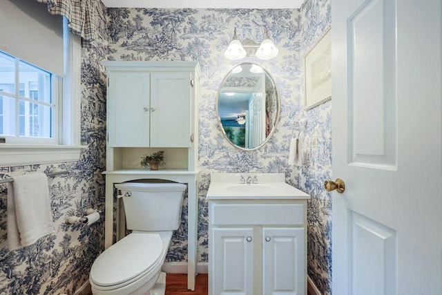 80 Summer St, Walpole, MA 02071 - half bath featuring wallpapered walls, toilet, vanity, and baseboards
