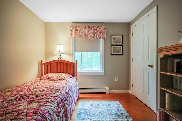 80 Summer St, Walpole, MA 02071 - bedroom featuring a baseboard heating unit, wood finished floors, and baseboards