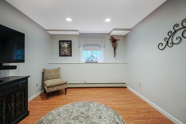 80 Summer St, Walpole, MA 02071 - living area with wood finished floors, baseboards, recessed lighting, and a baseboard radiator