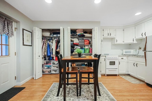 80 Summer St, Walpole, MA 02071 - kitchen with white appliances, white cabinets, light wood-style floors, light countertops, and recessed lighting