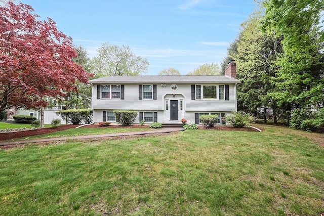 80 Summer St, Walpole, MA 02071 - bi-level home featuring a chimney and a front yard
