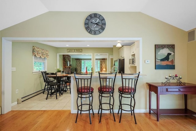 80 Summer St, Walpole, MA 02071 - dining space with vaulted ceiling, light wood-style floors, and baseboards