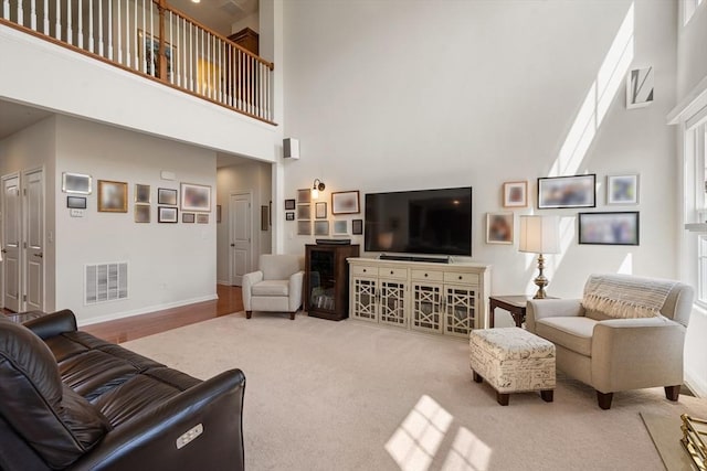 8 Heartwood Way Unit 8, Hopkinton, MA 01748 - living area with a towering ceiling, baseboards, and carpet flooring
