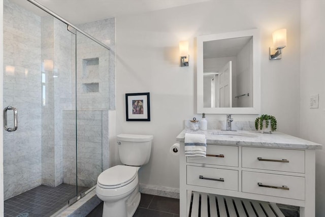 bathroom with an enclosed shower, vanity, toilet, and tile patterned flooring