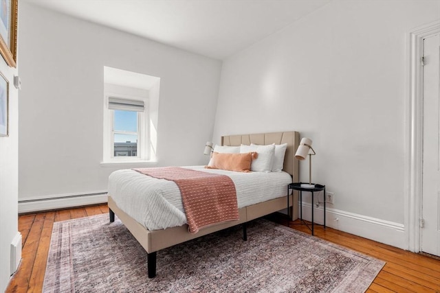 bedroom featuring a baseboard radiator and wood-type flooring