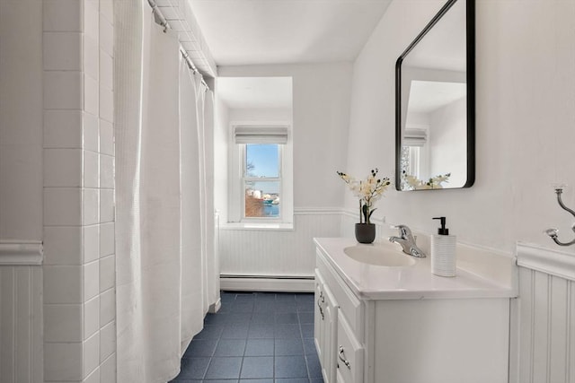 bathroom featuring tile patterned floors, a baseboard heating unit, and vanity