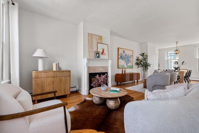 living room with light wood-type flooring and a baseboard radiator