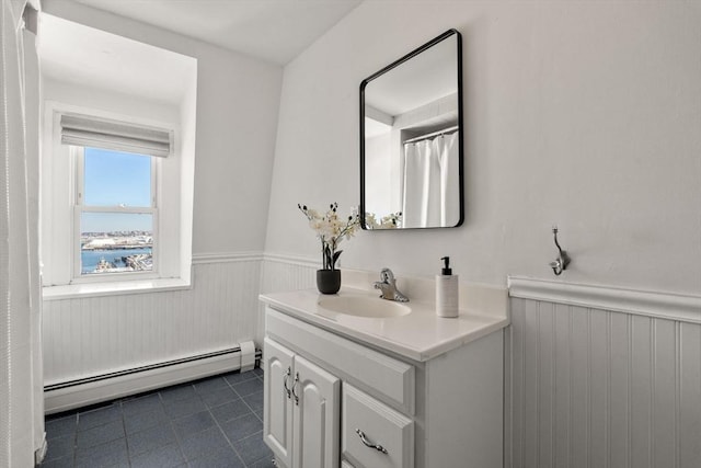 bathroom featuring baseboard heating, vanity, and tile patterned flooring