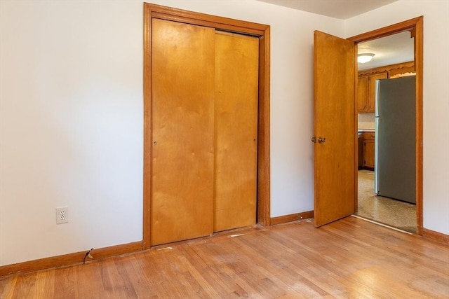 59 Mountain Rd, Holyoke, MA 01040 - unfurnished bedroom featuring freestanding refrigerator, light wood-style flooring, and a closet