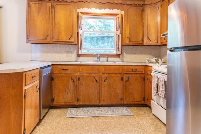 59 Mountain Rd, Holyoke, MA 01040 - kitchen featuring stainless steel appliances, brown cabinets, light countertops, and a peninsula