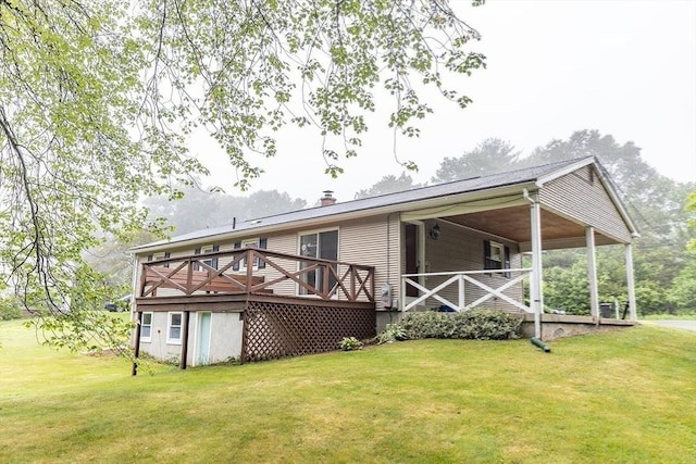 59 Mountain Rd, Holyoke, MA 01040 - rear view of house featuring a lawn, a deck, and a chimney
