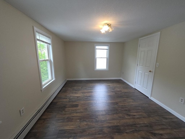 2018-2020 Prospect St, Palmer, MA 01080 - spare room featuring baseboard heating, healthy amount of natural light, dark wood-style floors, and baseboards