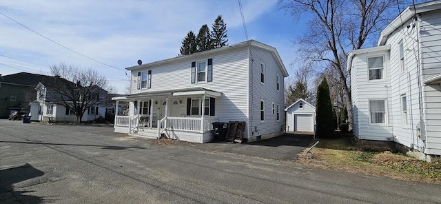 2018-2020 Prospect St, Palmer, MA 01080 - traditional-style home featuring covered porch, an outbuilding, a garage, and asphalt driveway