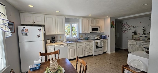 2018-2020 Prospect St, Palmer, MA 01080 - kitchen featuring white appliances, a sink, white cabinets, recessed lighting, and light countertops