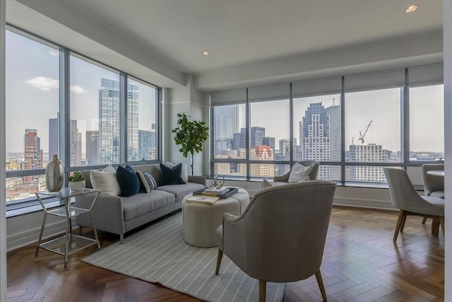 living room featuring parquet floors and a healthy amount of sunlight