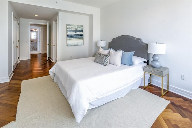 bedroom with dark parquet flooring