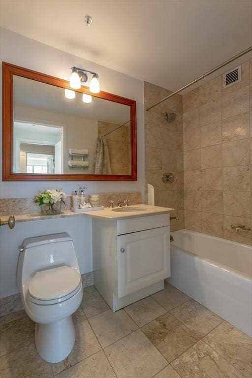 full bathroom with tiled shower / bath combo, vanity, tile patterned flooring, and toilet