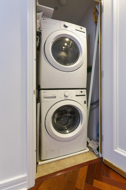 laundry area featuring stacked washing maching and dryer