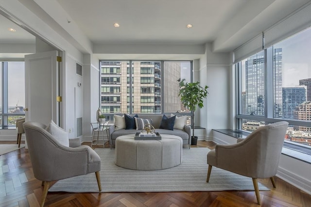 living room with parquet flooring and plenty of natural light