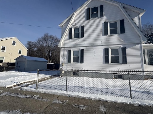 view of snow covered exterior featuring a shed