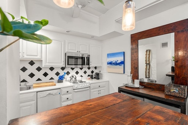 kitchen featuring white appliances, butcher block countertops, tasteful backsplash, and white cabinetry
