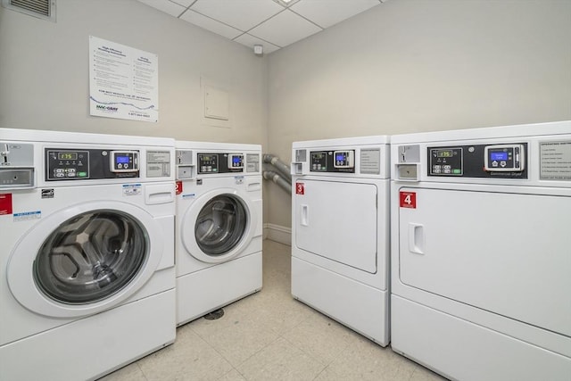 communal laundry room featuring washer and clothes dryer and light floors