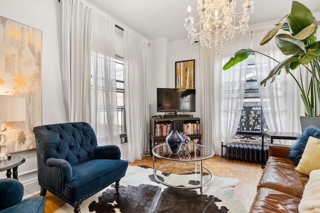 sitting room featuring a chandelier and radiator heating unit