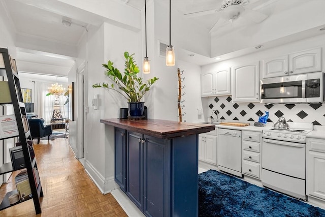 kitchen featuring white appliances, wood counters, white cabinets, tasteful backsplash, and crown molding