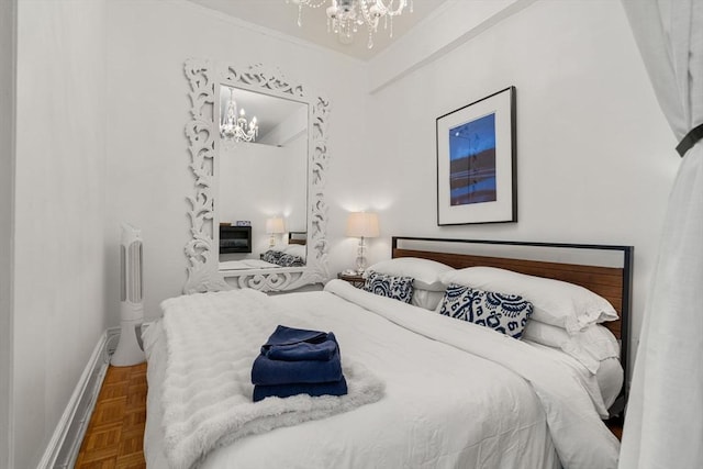 bedroom featuring a chandelier, baseboards, and crown molding