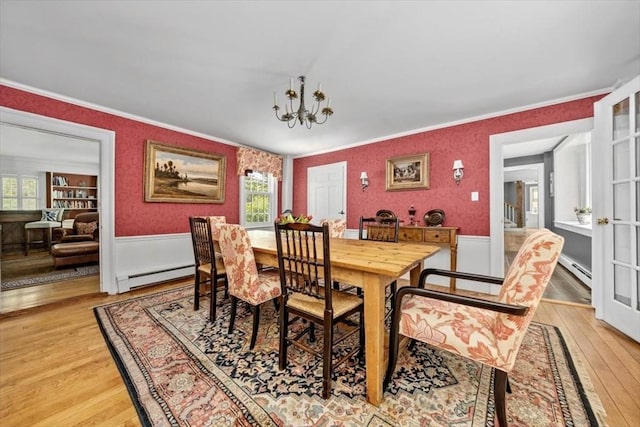 685 Highland St, Marshfield, MA 02050 - dining space with baseboard heating, ornamental molding, light wood-type flooring, plenty of natural light, and a wainscoted wall