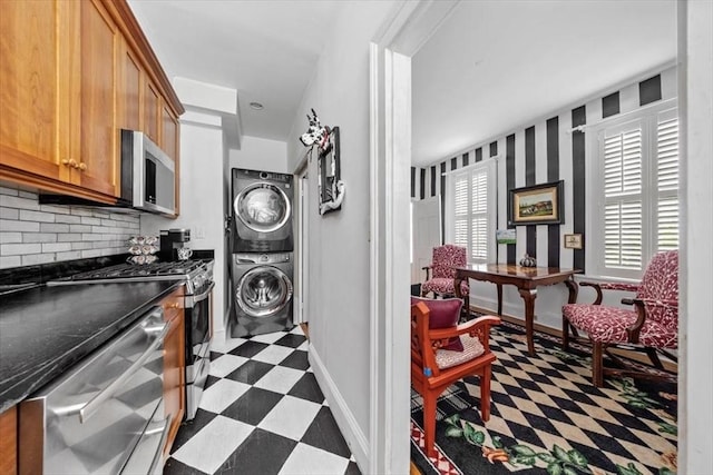 685 Highland St, Marshfield, MA 02050 - laundry room featuring stacked washing machine and dryer and dark floors
