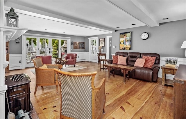 685 Highland St, Marshfield, MA 02050 - living area featuring light wood-type flooring, beam ceiling, baseboard heating, wainscoting, and french doors
