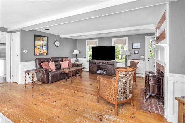 685 Highland St, Marshfield, MA 02050 - living room with a wainscoted wall, baseboard heating, beamed ceiling, light wood finished floors, and a decorative wall