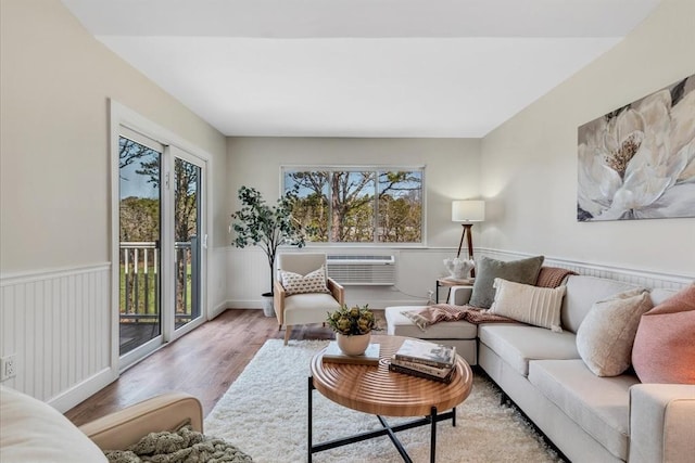 living room with wainscoting and wood finished floors