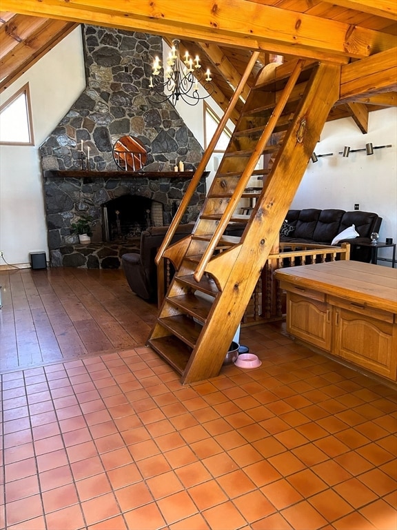 interior space featuring tile floors, beamed ceiling, and a fireplace