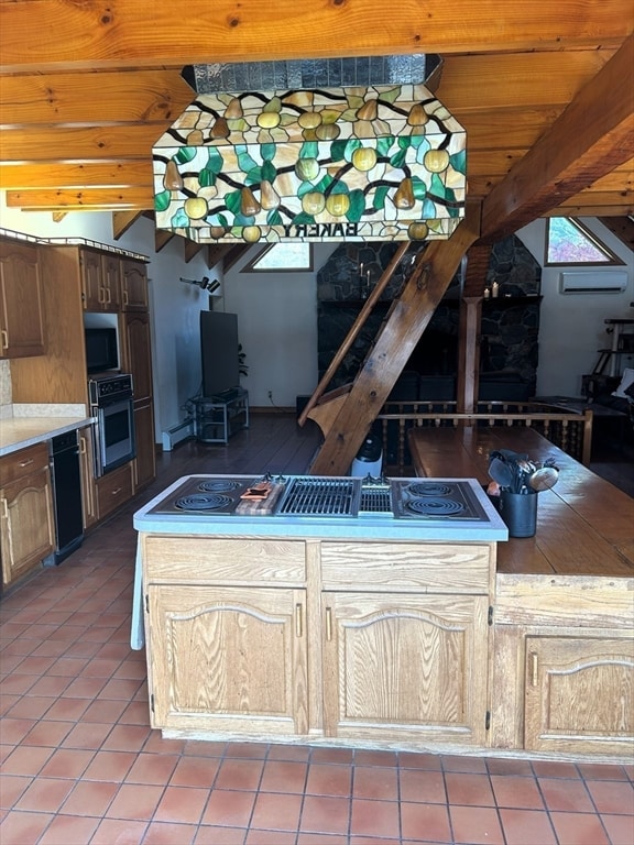 kitchen with appliances with stainless steel finishes, beam ceiling, tile floors, and an AC wall unit