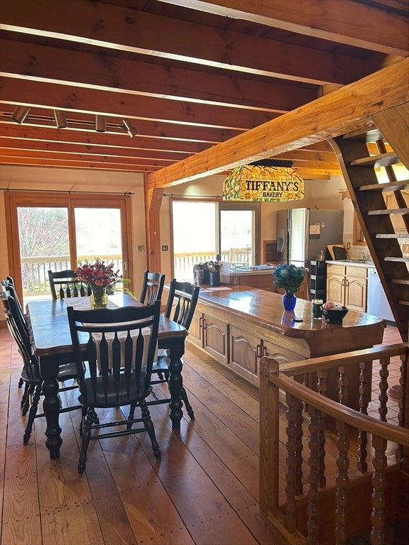 dining room featuring hardwood / wood-style flooring and beam ceiling