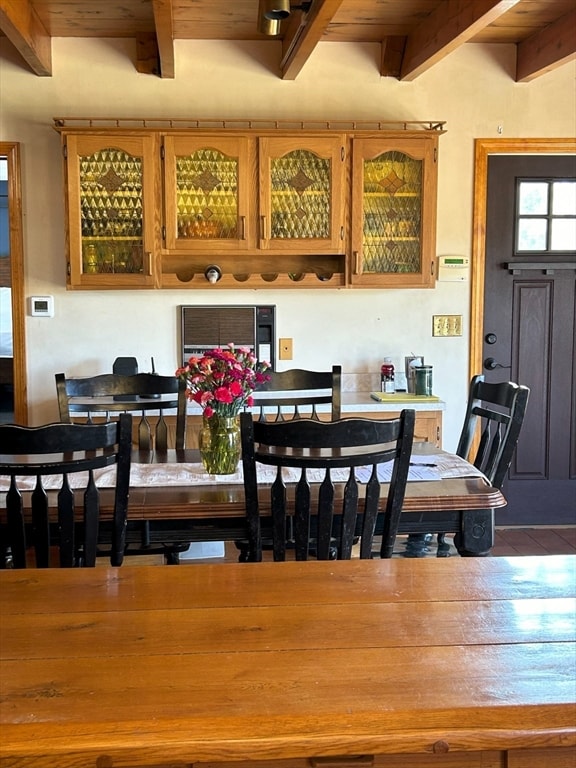 dining room featuring beam ceiling and wood ceiling