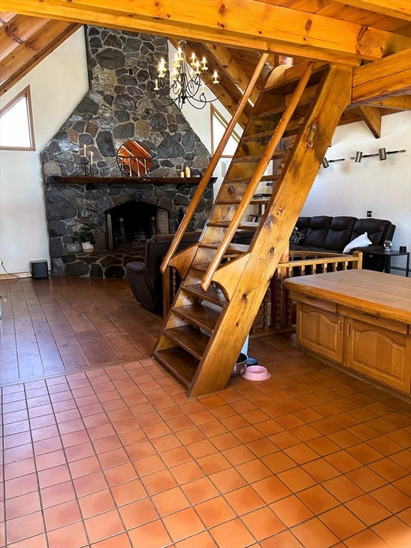 interior space with a fireplace, beam ceiling, tile floors, and a chandelier