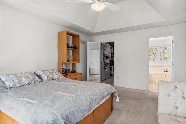 bedroom featuring ceiling fan, light carpet, baseboards, a spacious closet, and a closet