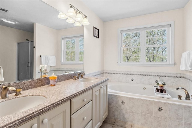 bathroom featuring double vanity, a sink, a garden tub, and tile patterned floors