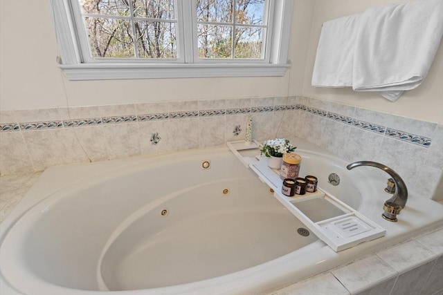 bathroom featuring a tub with jets