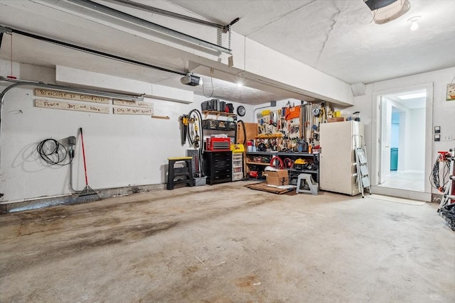 garage with a workshop area and freestanding refrigerator