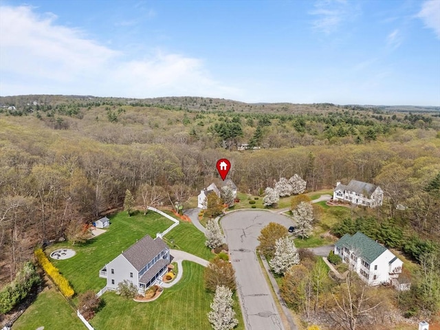 birds eye view of property featuring a wooded view
