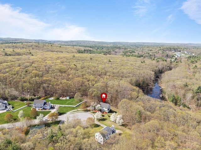 birds eye view of property featuring a wooded view