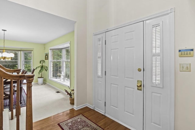 63 Forge Rd, Sharon, MA 02067 - foyer entrance with a chandelier, dark wood-type flooring, and baseboards